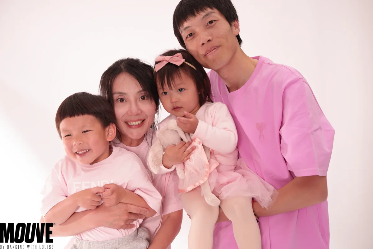 A happy family at MOUVE dance school in Hendon — parents with a young boy and toddler girl in a pink tutu, MOUVE logo visible